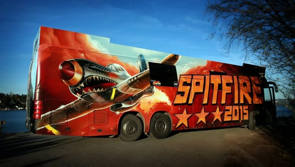 Fargerik buss med stor Spitfire-grafikk og teksten «SPITFIRE 2015» i oransje.